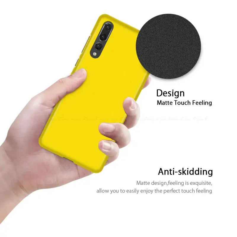 a person holding a yellow phone with a black circle on it