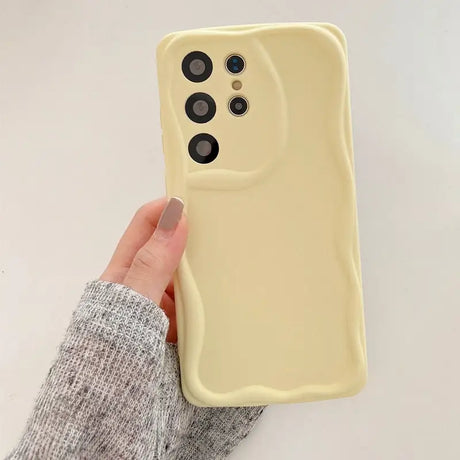 A person holding a yellow phone case