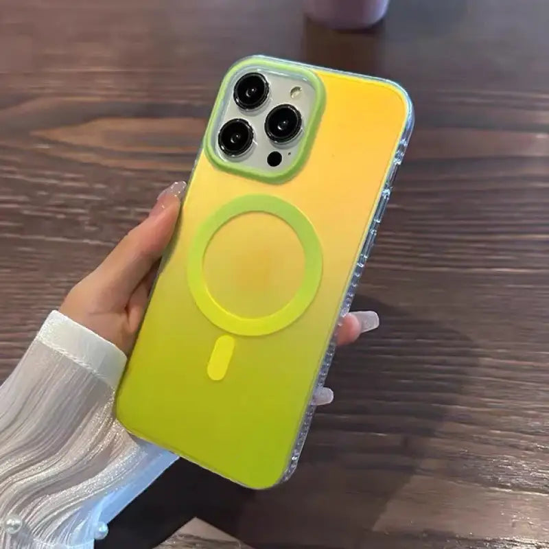 a person holding a yellow phone case