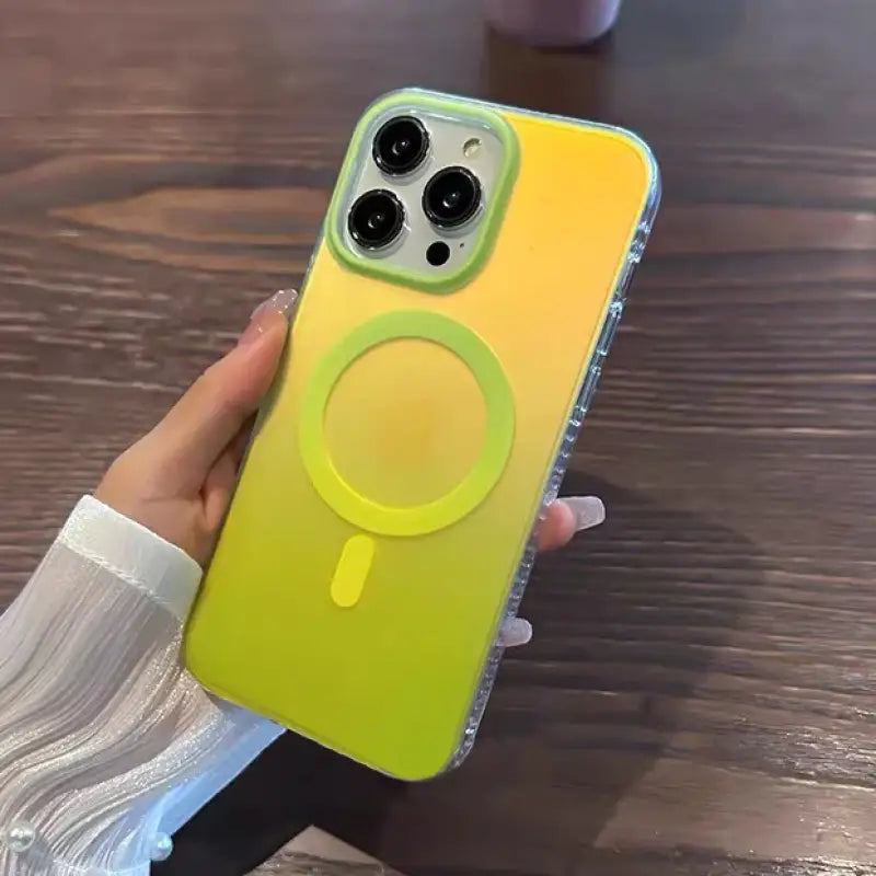 A person holding a yellow phone case