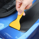 someone is cleaning a car with a yellow brush