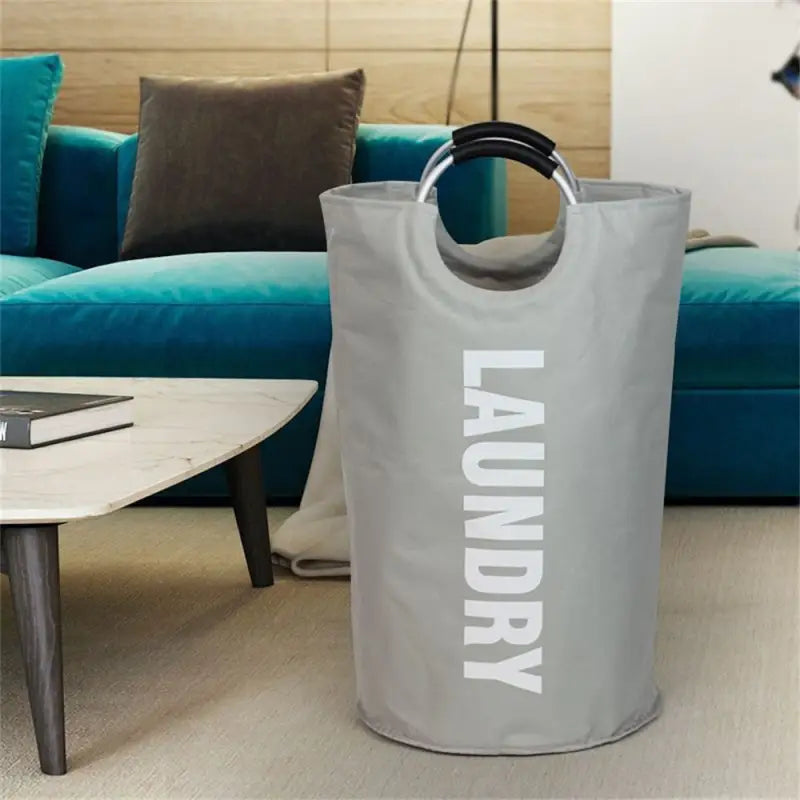 a grey laundry bag sitting on a coffee table