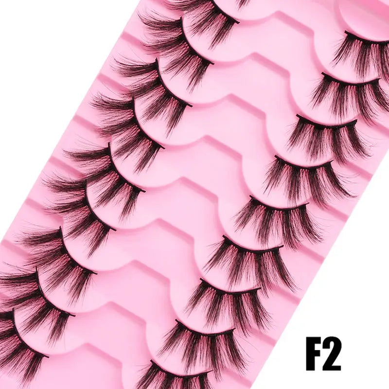 a close up of a pink tray with eyelashes on it