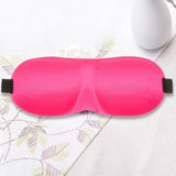 a pink eye mask with a black band