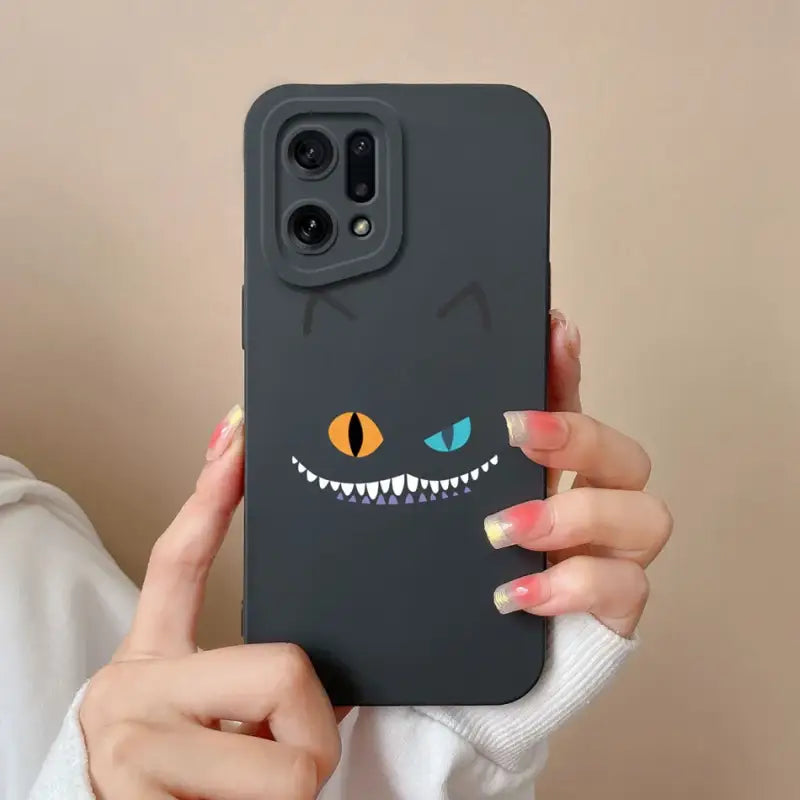 someone holding a phone with a black case with a cartoon cat face