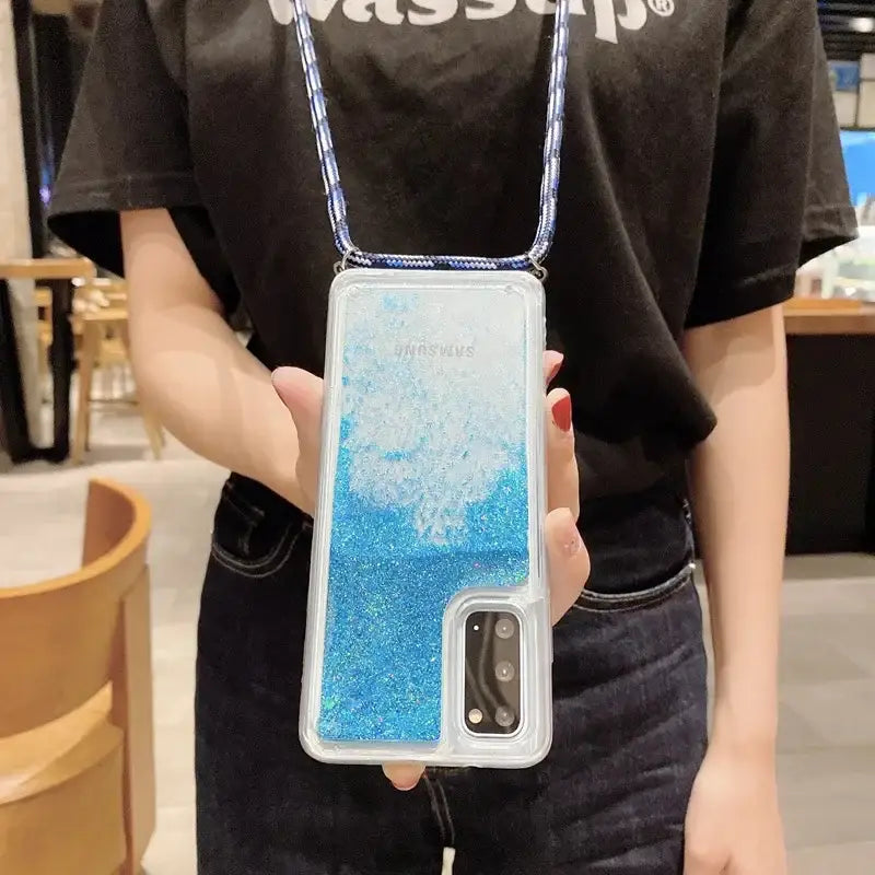 someone holding a phone case with a blue liquid inside of it