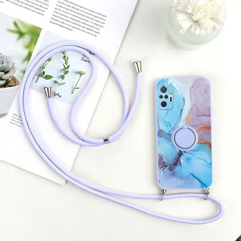 a phone case with a purple strap and a white flower