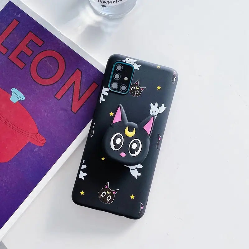 a phone case with a cat and a book