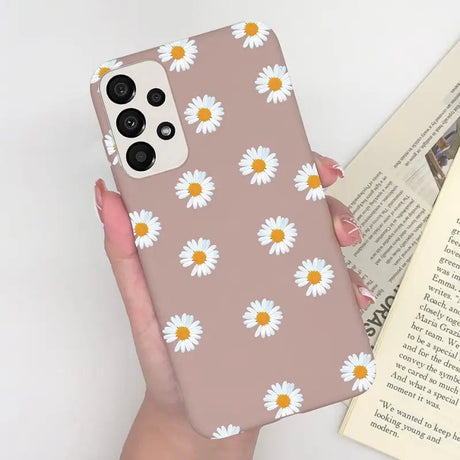 someone holding a phone case with a daisy pattern on it