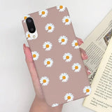 someone holding a phone case with a daisy pattern on it