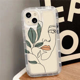 a phone case with a face and leaves on it