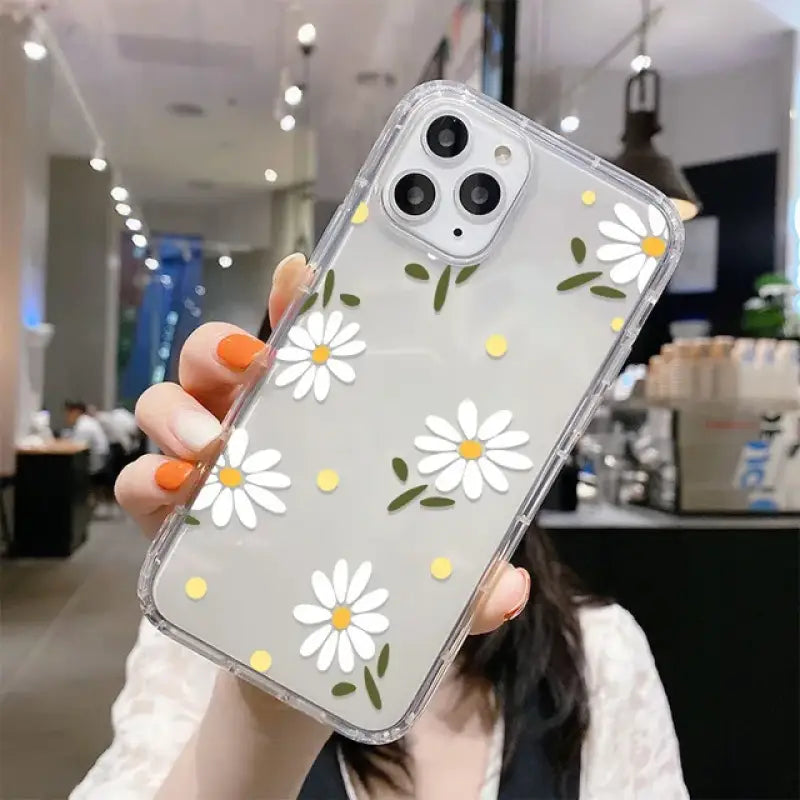 someone holding a phone case with a flower design on it