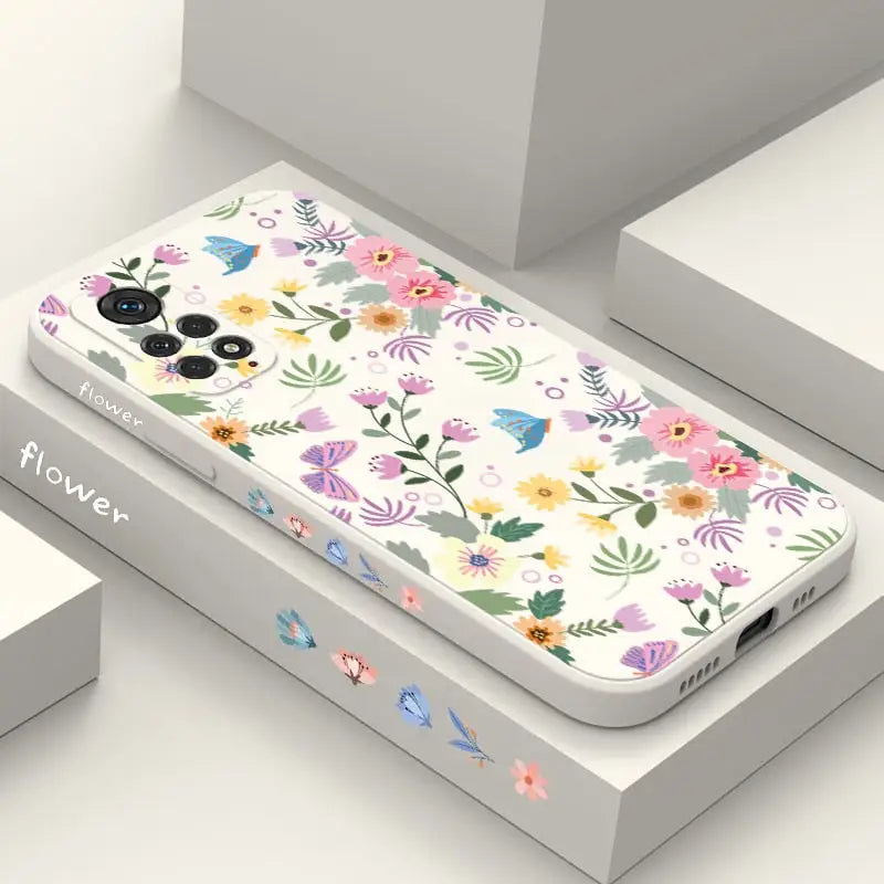 A phone case with flowers and birds on it