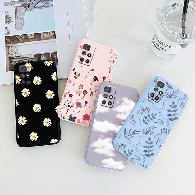 a phone case with flowers and clouds on it