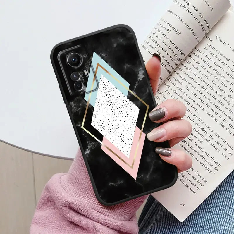 Someone holding a phone case with a geometric design on it