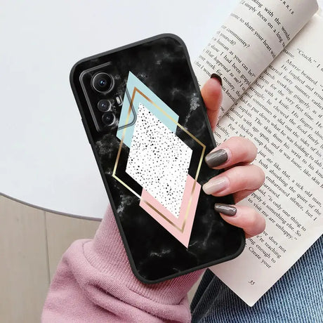 Someone holding a phone case with a geometric design on it