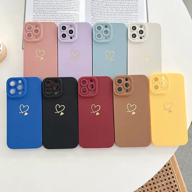 a phone case with heart and heart charms