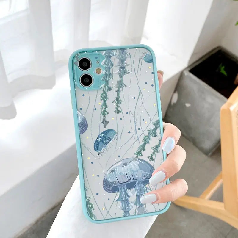 someone holding a phone case with a jelly fish design