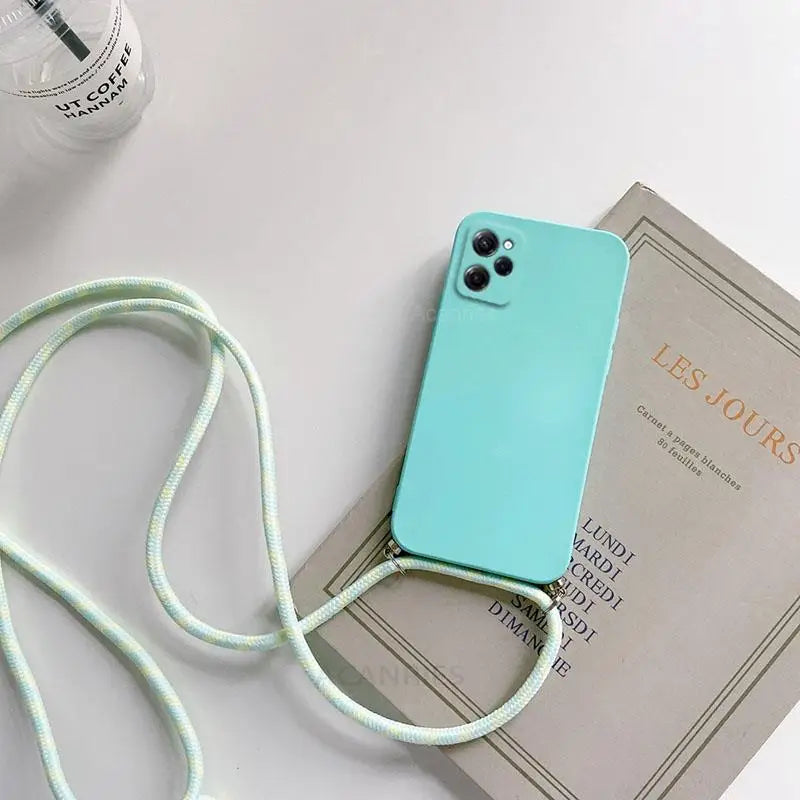 a blue phone case sitting on top of a book