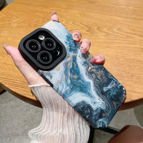 Someone holding a phone case with a marble pattern on it