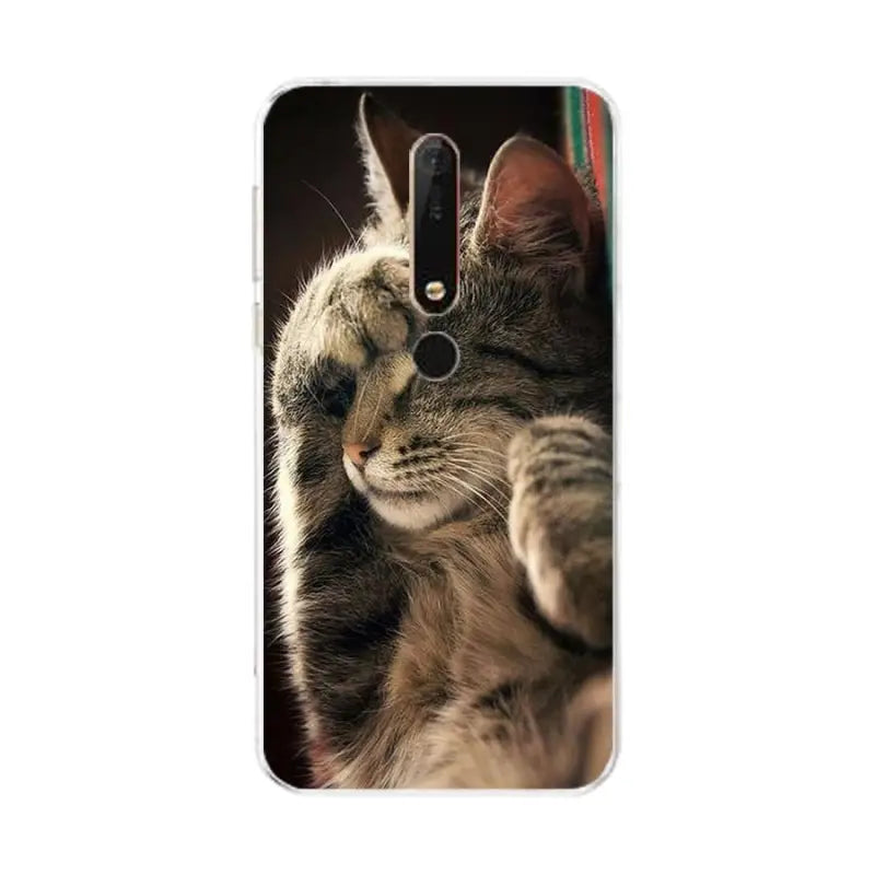 a cat looking at the camera on a white phone case