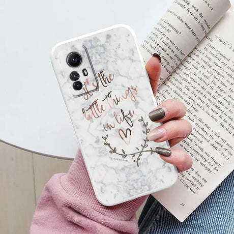 Someone holding a phone case with a quote on it