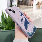 a woman holding a phone case with a whale on it