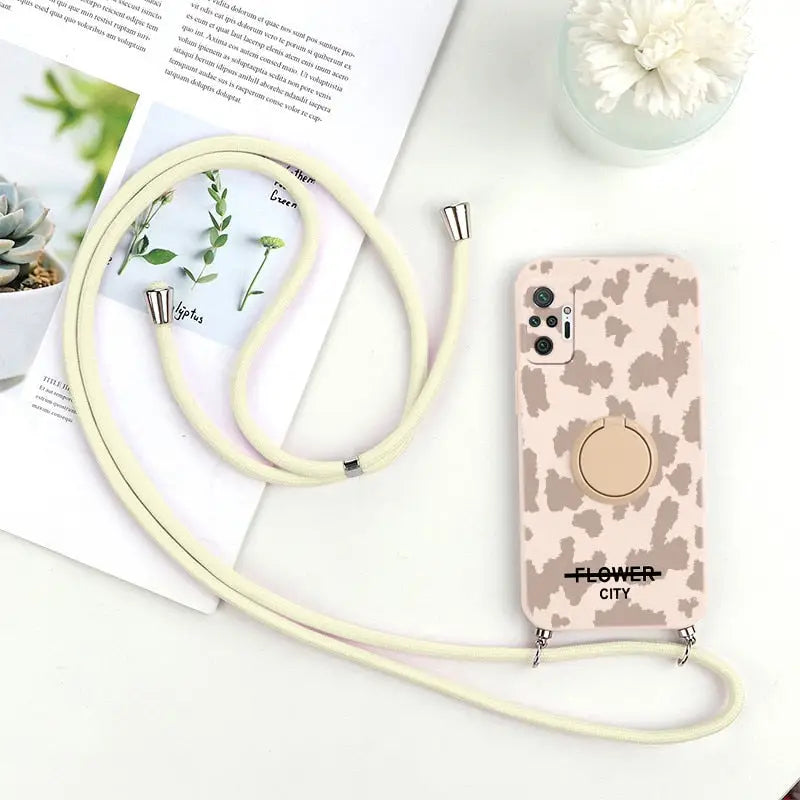 a phone case with a white cord and a flower