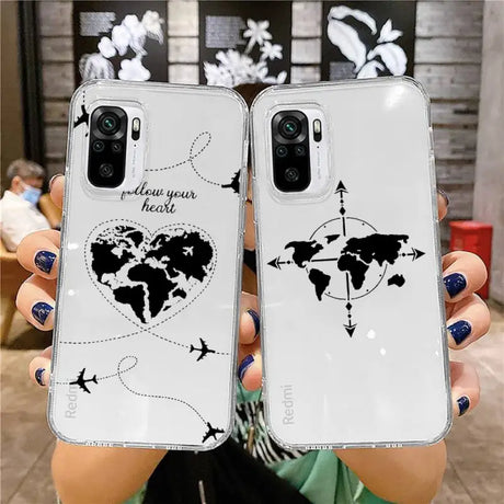 a woman holding up two iphone cases with a world map on them