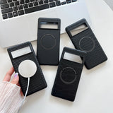 Phone cases with circular cutouts for wireless charging, displayed on a white surface next to a laptop keyboard.