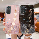 a woman holding two phone cases with heart charms