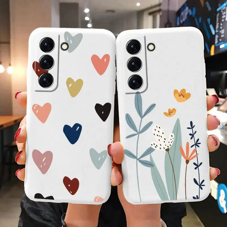 two phone cases with hearts and flowers