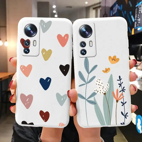 two phone cases with hearts and flowers