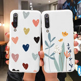 two phone cases with hearts and flowers