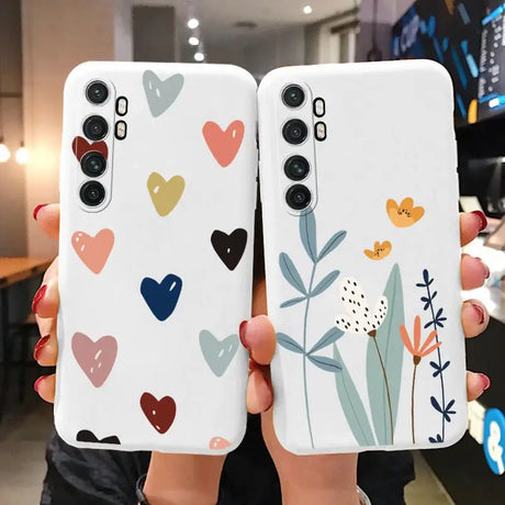 two phone cases with hearts and flowers