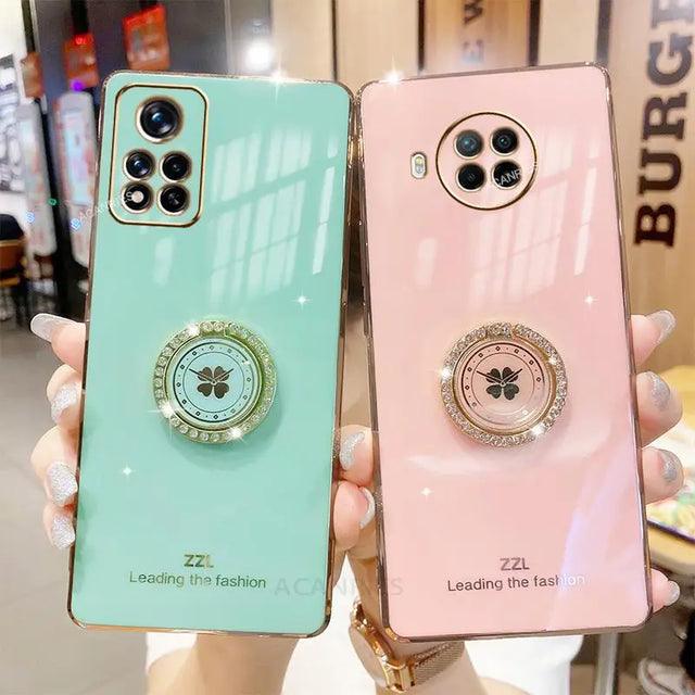 two phone cases with a phone ring on the back