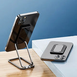 the iphone stand is on a desk next to a phone
