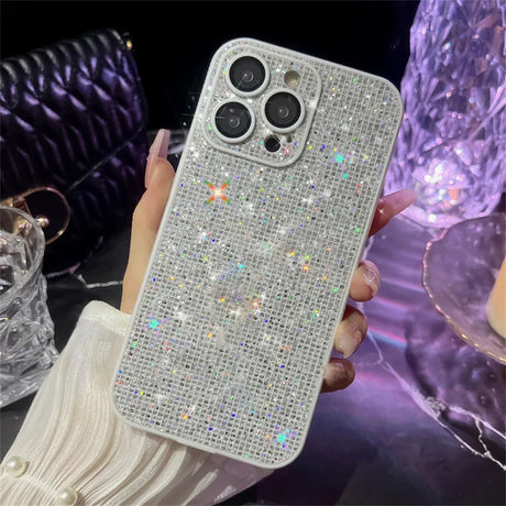 someone holding a phone with a diamond case on it