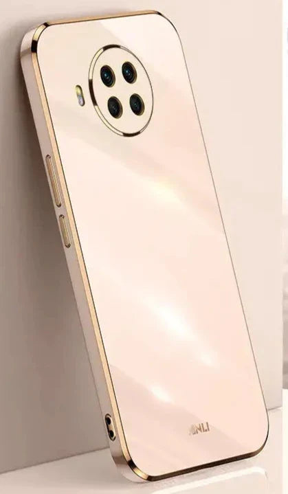 A phone with a gold case on it