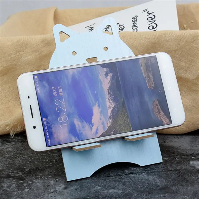 a phone holder with a cat on it