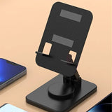 there is a cell phone and a cell phone stand on a table
