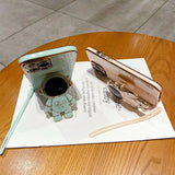 a phone and a pen on a table