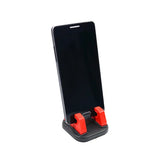 the red phone stand is attached to the phone