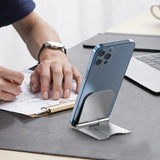 a man is using a phone stand on a desk