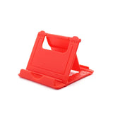 a red plastic phone stand with a white background