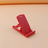 a red phone stand on a white surface