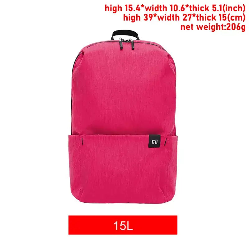 a picture of a pink backpack with a black handle and a red tag