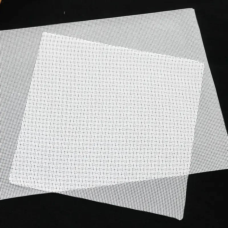 a piece of white plastic mesh mesh on a black background
