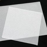 a piece of white plastic mesh on a black background