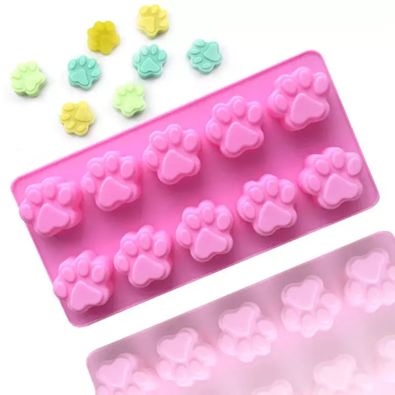 there are a few pieces of pink and green candy in a mold